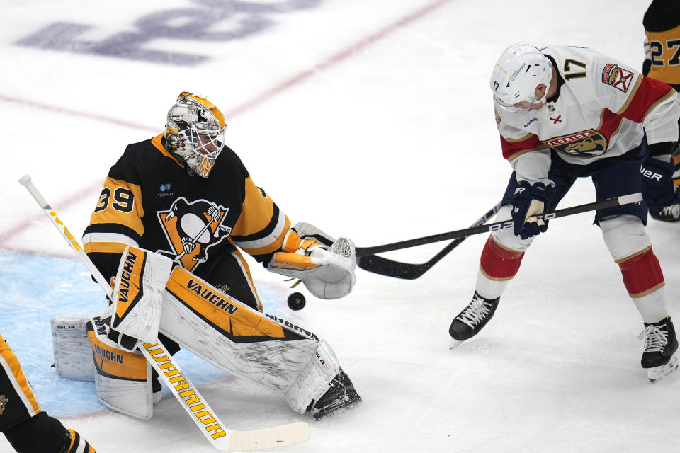 Florida Panthers' Evan Rodrigues (17) backhands a rebound past Pittsburgh Penguins goaltender Alex Nedeljkovic (39) for a goal during the first period of an NHL hockey game in Pittsburgh, Friday, Jan. 26, 2024. (AP Photo/Gene J. Puskar)