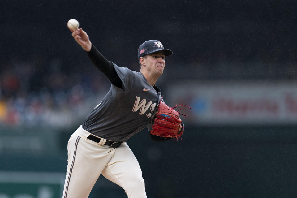 Washington Nationals starting pitcher Jackson Rutledge delivers in the rain during the third inning of a baseball game against the Atlanta Braves, Sunday, Sept. 24, 2023, in Washington. (AP Photo/Stephanie Scarbrough)