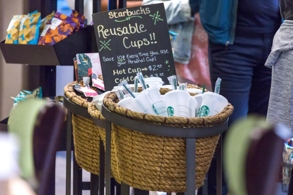 New York, USA - 17 May, 2019: Starbucks reusable coffee cups on sale in cafe in New York. People who use their own cup get discount for coffee