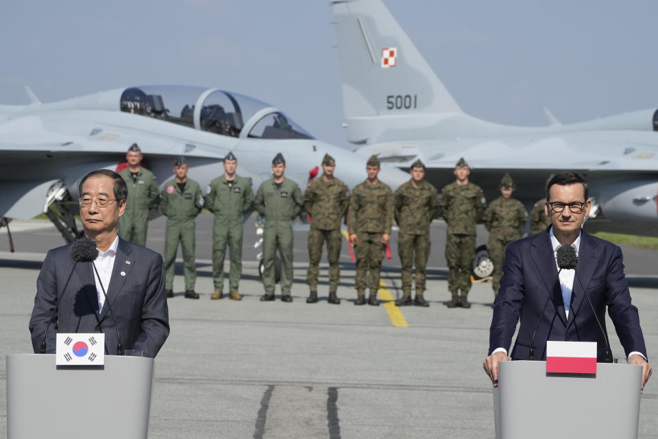 South Korean Prime Minister Han Duck-Soo, left, and his Polish host, Prime Minister Mateusz Morawiecki, right, speak to the media following talks on regional security and examine FA-50 fighter jets that Poland recently bought from South Korea, along with other military equipment, at an air base in Minsk Mazowiecki, eastern Poland, Wednesday, Sept. 13, 2023. Han was in Poland for talks on regional security amid war in neighboring Ukraine, and also to discuss military and nuclear energy cooperation. (AP Photo/Czarek Sokolowski)