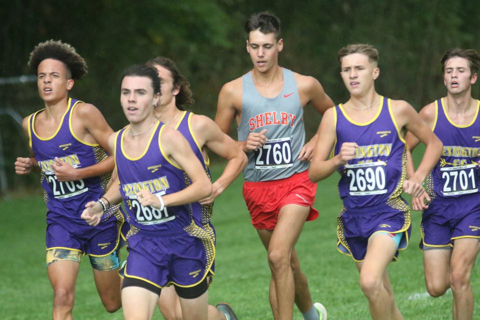 Shelby's Huck Finnegan kept pace with a pack of Lexington runners early in the 2022 Richland County Cross Country Invitational on Monday.