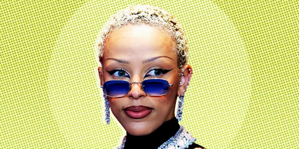 Doja Cat, an American rapper, singer, songwriter, and record producer on a light green patterned background