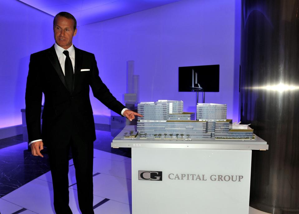 Vlad Doronin standing next to a 3D model that says "Capital Group"