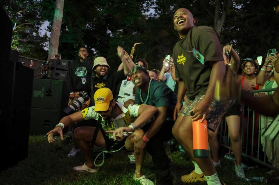 Jaroby Augusta, left, Stevante Clark, center, and rapper LaRussell get excited as rapper Isaiah Rashad performs on the first day of the Sol Blume R&B festival on Saturday.