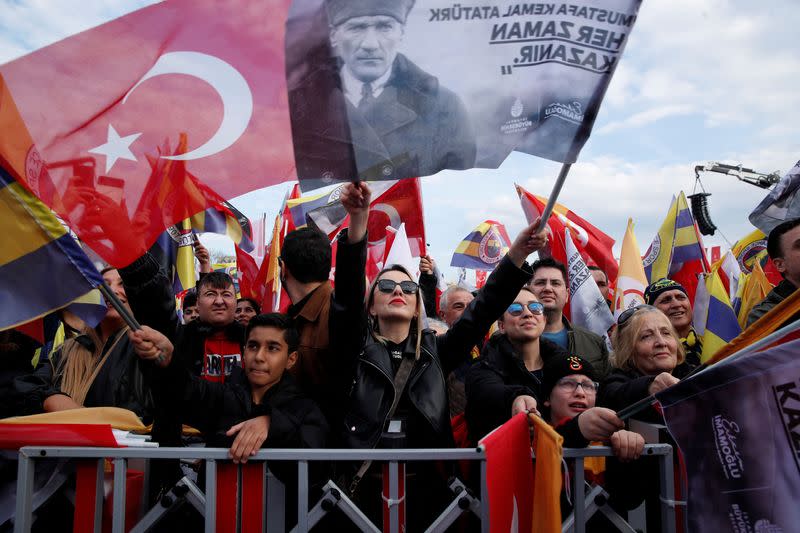 People wave flags in support of Turkish soccer teams Fenerbahce and Galatasaray during a gathering in Istanbul