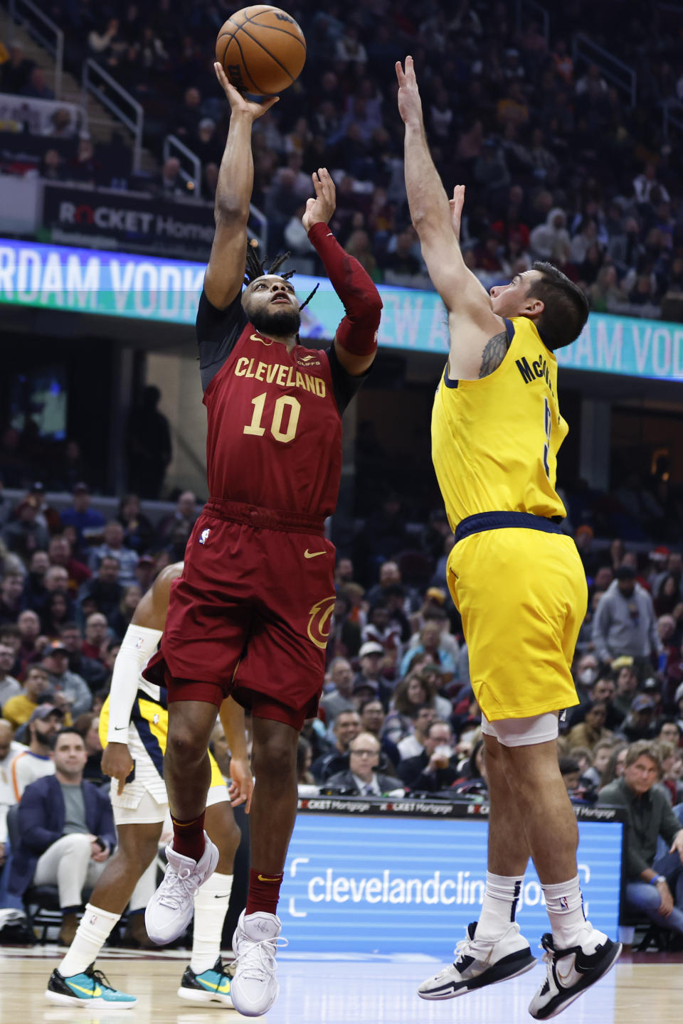 Cleveland Cavaliers guard Darius Garland (10) shoots against Indiana Pacers guard T.J. McConnell (9) during the first half of an NBA basketball game, Friday, Dec. 16, 2022, in Cleveland. (AP Photo/Ron Schwane)