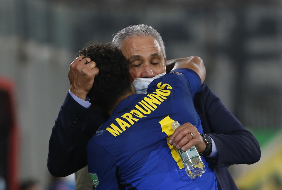 Brazil's coach Tite and player Marquinhos celebrate their team's 1-0 victory over Chile during a qualifying soccer match for the FIFA World Cup Qatar 2022 at Monumental Stadium in Santiago, Chile, Thursday, Sept. 2, 2021. (Claudio Reyes/Pool via AP)