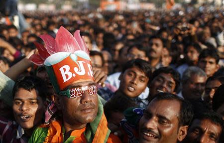 A supporter of India's main opposition Bharatiya Janata Party (BJP) wears a hat and goggles supporting the party's lotus symbol during a rally being addressed by Hindu nationalist Narendra Modi, prime ministerial candidate for BJP, in the northern Indian city of Agra November 21, 2013. REUTERS/Anindito Mukherjee