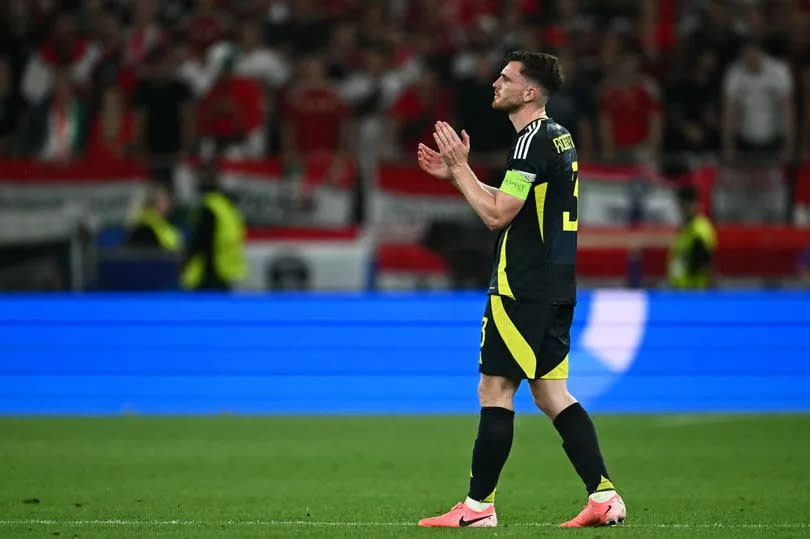 Andrew Robertson applauds at the end of the UEFA Euro 2024 Group A football match between Scotland and Hungary at the Stuttgart Arena in Stuttgart on June 23, 2024.