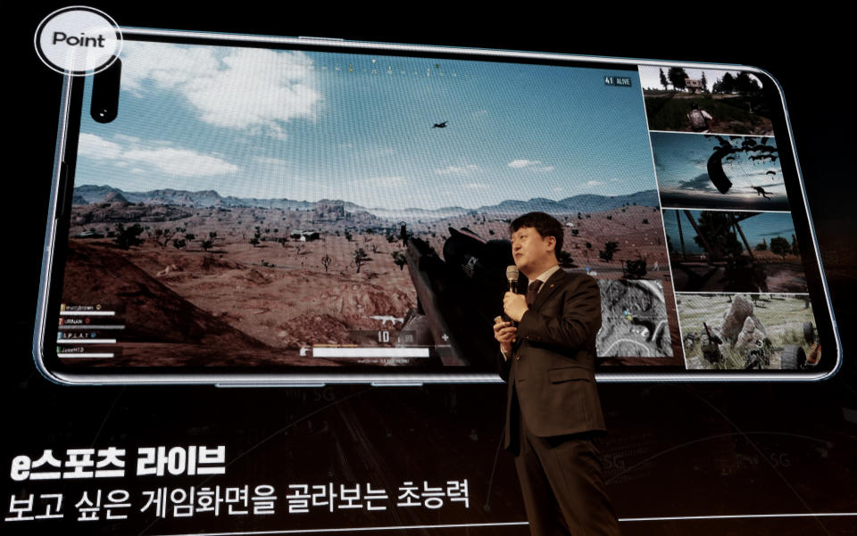 Park Hyun-jin, senior vice president of KT's 5G Business Unit., speaks during a press conference on 5G service at its  headquarters in Seoul, South Korea, Tuesday, April 2, 2019. KT will be launching commercial 5G services nationwide across South Korea on April 5, in line with its competitors. The signs read: " esports live." (AP Photo/Ahn Young-joon)