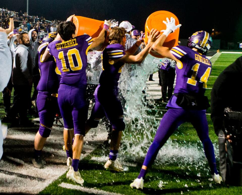 Escalon High head coach gets an ice bath from the players as they celebrate their win over Hilmar. Escalon High School took on Hilmar High football during the 2021 CIF Sac-Joaquin Football Playoffs - Division V at Saint Mary’s High School in Stockton, Ca. Escalon came out on top as the champions with a 20-13 win over Hilmar.