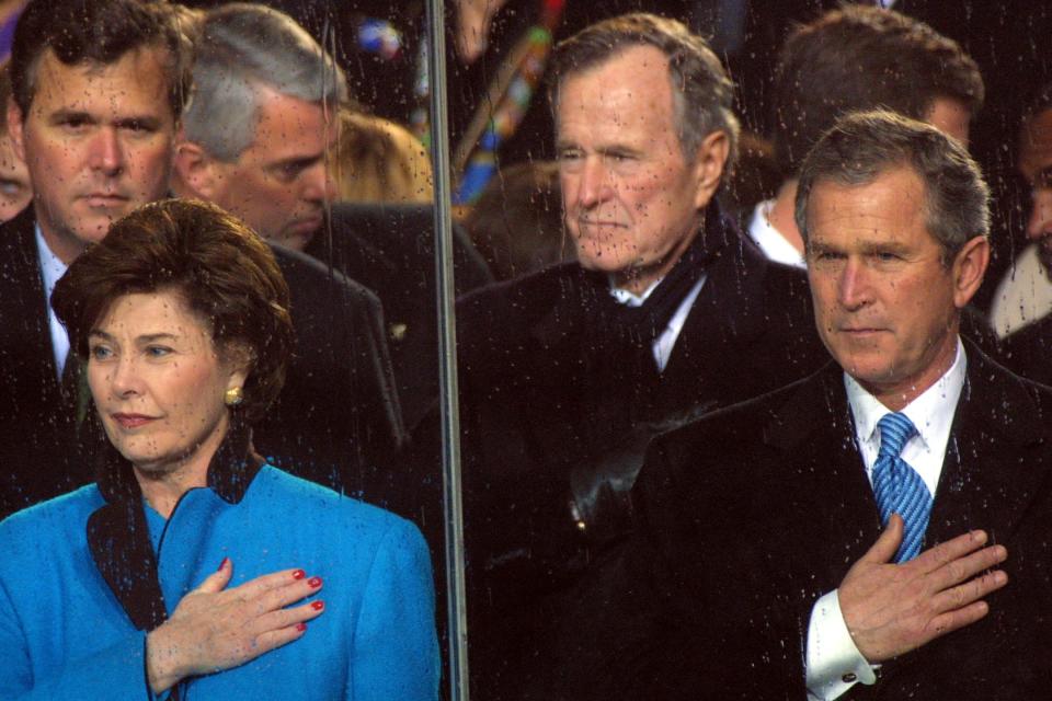 George W. Bush and Laura Bush hold their hands over their hearts during his inauguration in 2001.