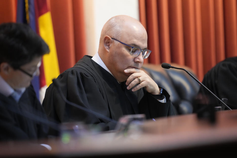 Colorado Supreme Court Chief Justice Brian D. Boatright listens as attorneys argue before the court on Wednesday, Dec. 6, 2023, in Denver. The oral arguments before the court were held after both sides appealed a ruling by a Denver district judge on whether to allow former President Donald Trump to be included on the state's general election ballot. (AP Photo/David Zalubowski, Pool)