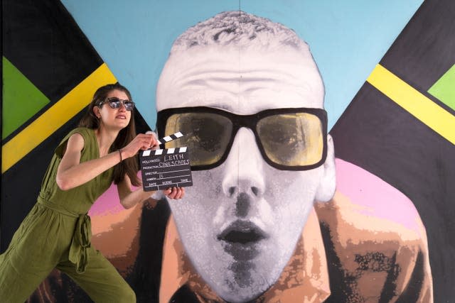 Isobel Salamon poses alongside Leith Trainspotting murals