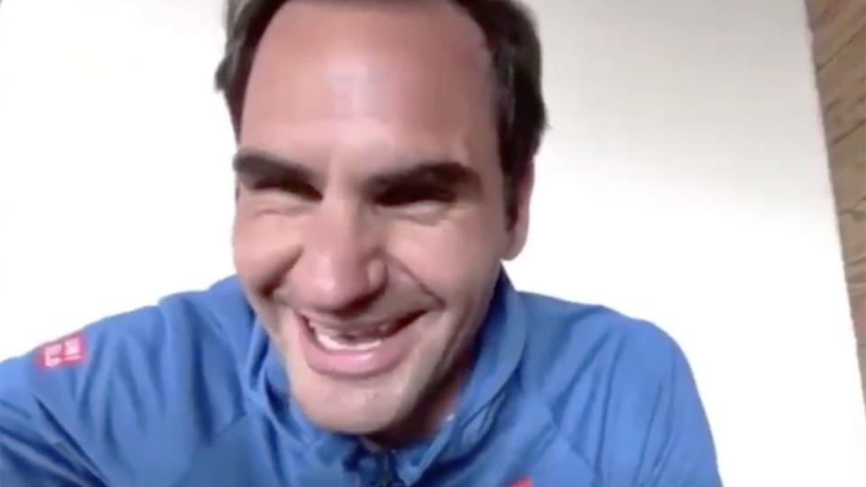 Pictured here, Roger Federer laughs after his coach interrupts a live chat to check up on him.