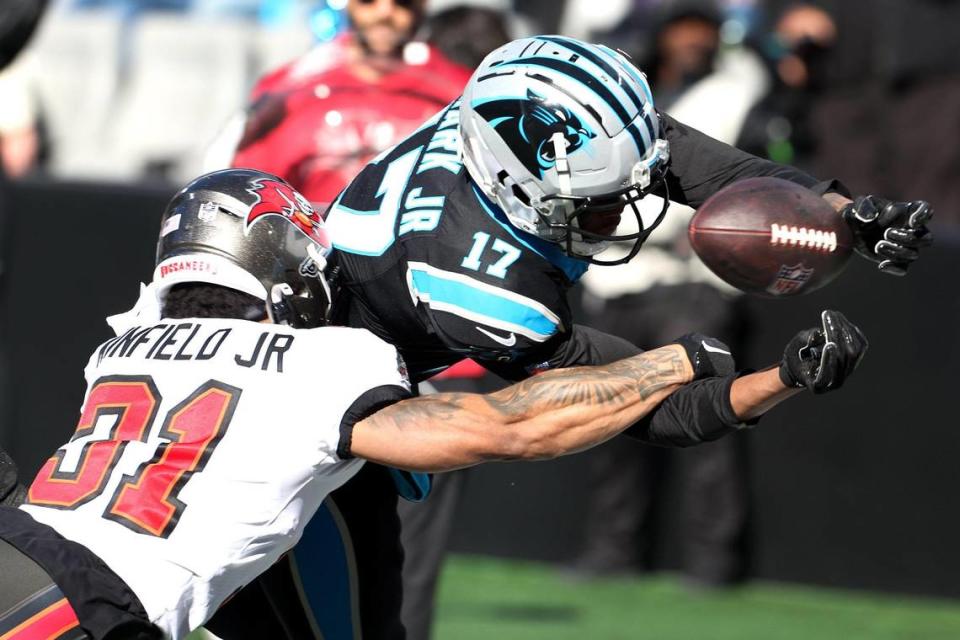 Carolina Panthers wide receiver DJ Chark, right, fumbles the football at the goal line as he is hit by Tampa Bay Buccaneers safety Antoine Winfield Jr., left, during second-quarter action at Bank of America Stadium in Charlotte, NC on Sunday, January 7, 2024.