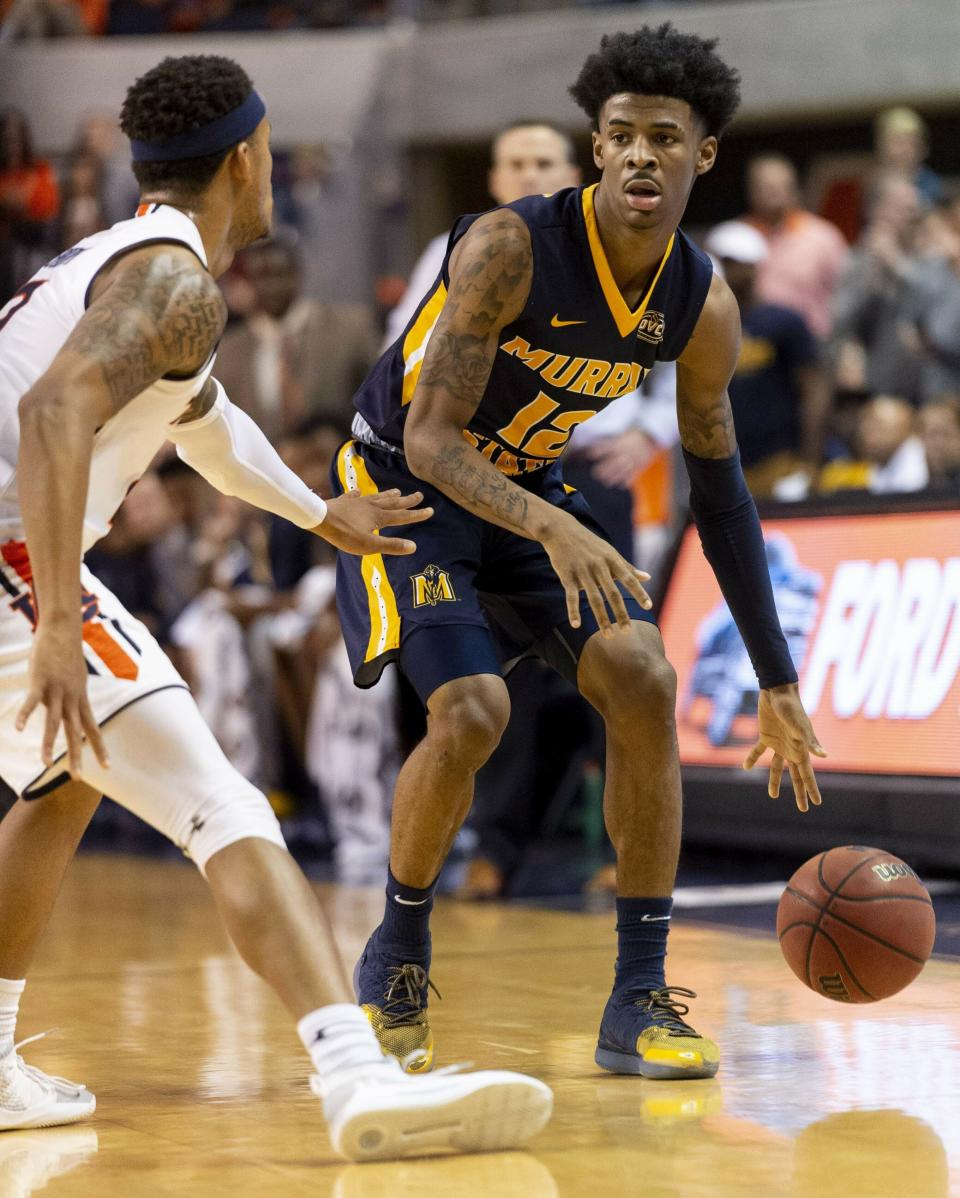 FILE - In this Dec. 22, 2018, file photo, Murray State guard Ja Morant (12) works around Auburn guard Bryce Brown (2) during the first half of an NCAA college basketball game, in Auburn, Ala. Morant, Darius Garland and Coby White make up a clear top tier of point guards in next week’s NBA draft. (AP Photo/Vasha Hunt, File)