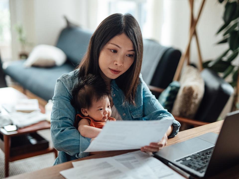Young mother with baby daughter working from home
