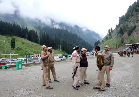 Indian policemen stand guard at a base camp for a Hindu pilgrimage to the holy cave of Amarnath, near Pahalgam