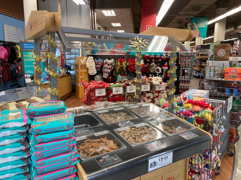 A dog food buffet at Petco decorated for the holidays.