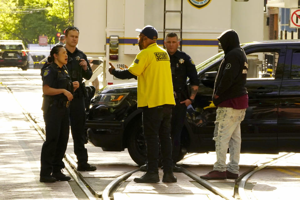 Frank Turner, center, pleads with Sacramento Police officers to allow him to look for his son at the scene of a mass shooting In Sacramento, Calif., April 3, 2022. (AP Photo/Rich Pedroncelli)