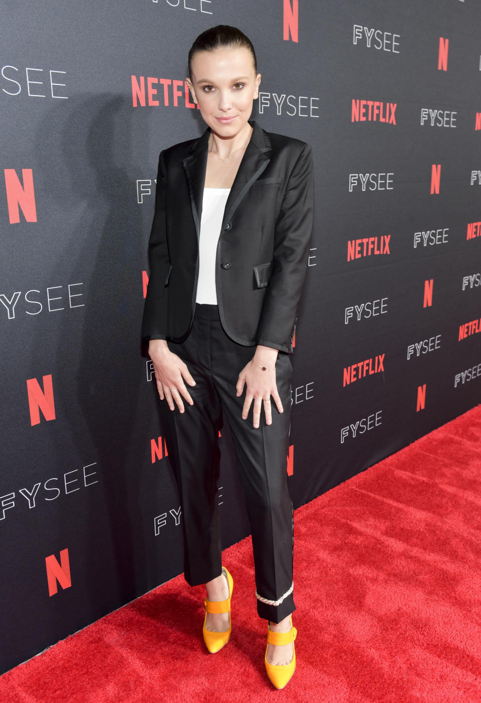 <p>The Calvin Klein muse looked chic in a black suit and white top which she wore with patent yellow heels to add a pop of colour. <em>[Photo: Getty]</em> </p>