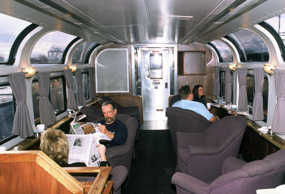 This undated photo provided by Amtrak shows passengers relaxing in a lounge car aboard the California Zephyr, which runs between Emeryville, Calif., and Reno, Nev. The 236-mile journey offers beautiful views as well as history. It crosses the Sierra Nevada mountain range and follows the same course as the historic Transcontinental Railroad, a 19th century engineering feat that bolstered the nation’s western expansion. The Zephyr’s ultimate destination is Chicago, a 51-hour trip from Emeryville. (AP Photo/Amtrak)