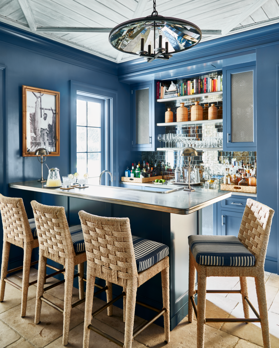 mirrored subway tile on a backsplash in a blue kitchen