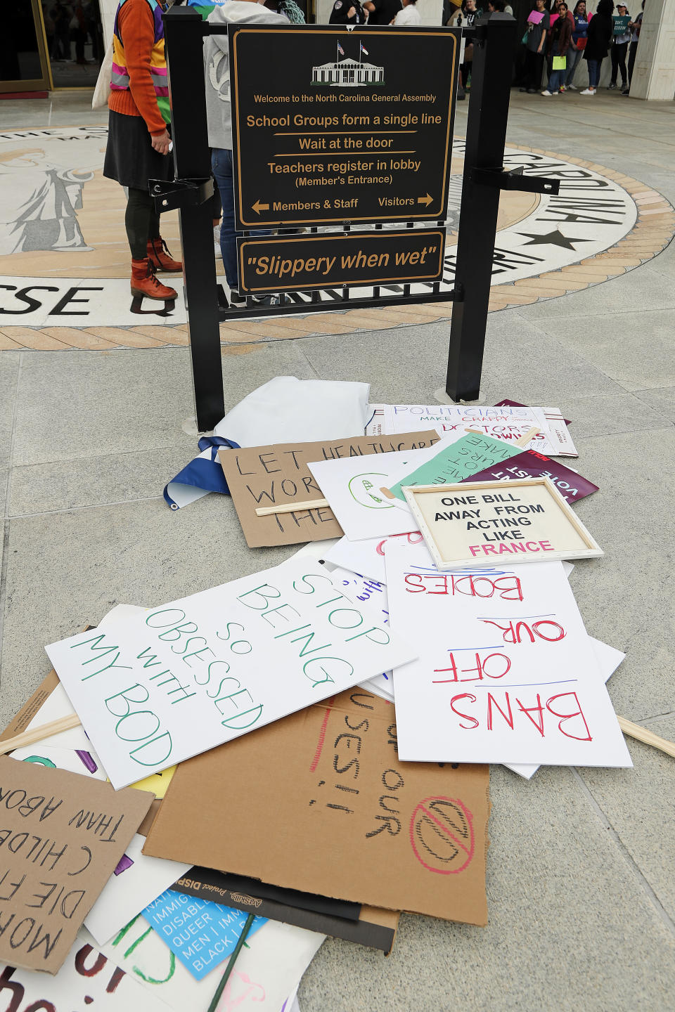 Abortion rights supporters signs pile up near the entrance of the general assembly following a rally at Bicentennial Plaza put on by Planned Parenthood South Atlantic in response to a bill before the North Carolina Legislature, Wednesday, May 3, 2023, in Raleigh, N.C. (AP Photo/Karl B DeBlaker)