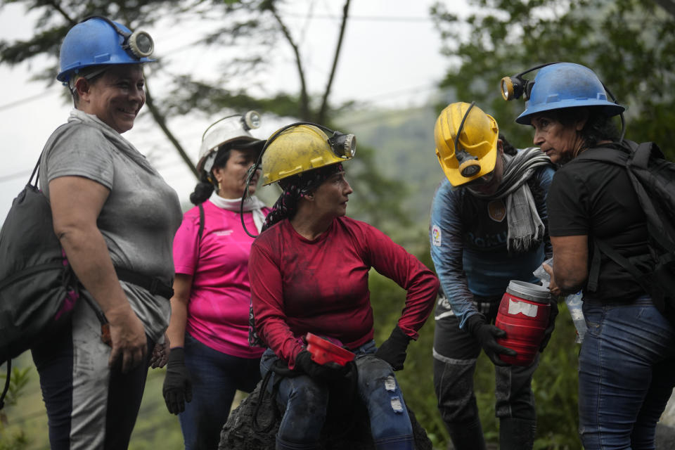 Female emerald miners chat after work at an informal mine near the town of Coscuez, Colombia, Thursday, Feb. 29, 2024. The lack of job opportunities, combined with the hope of a find that will make them rich, has pushed the women into mining. (AP Photo/Fernando Vergara)