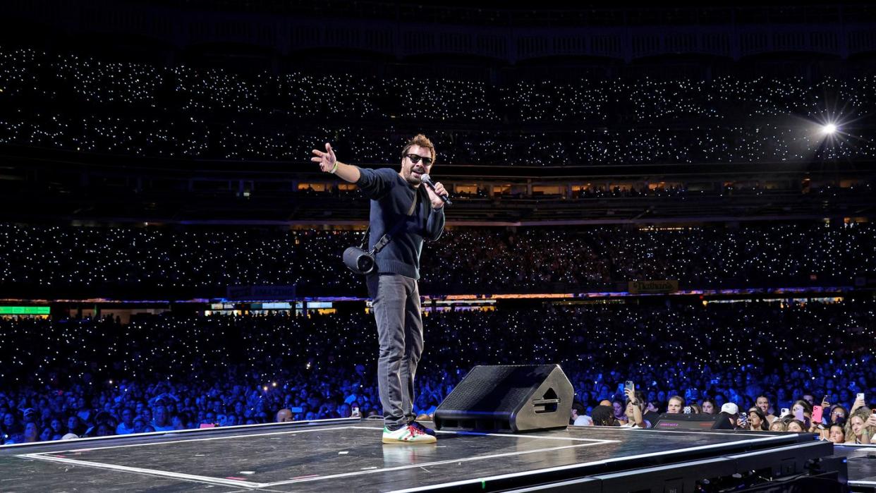 jimmy fallon performing at jonas brothers concert wearing jbl speaker on strap