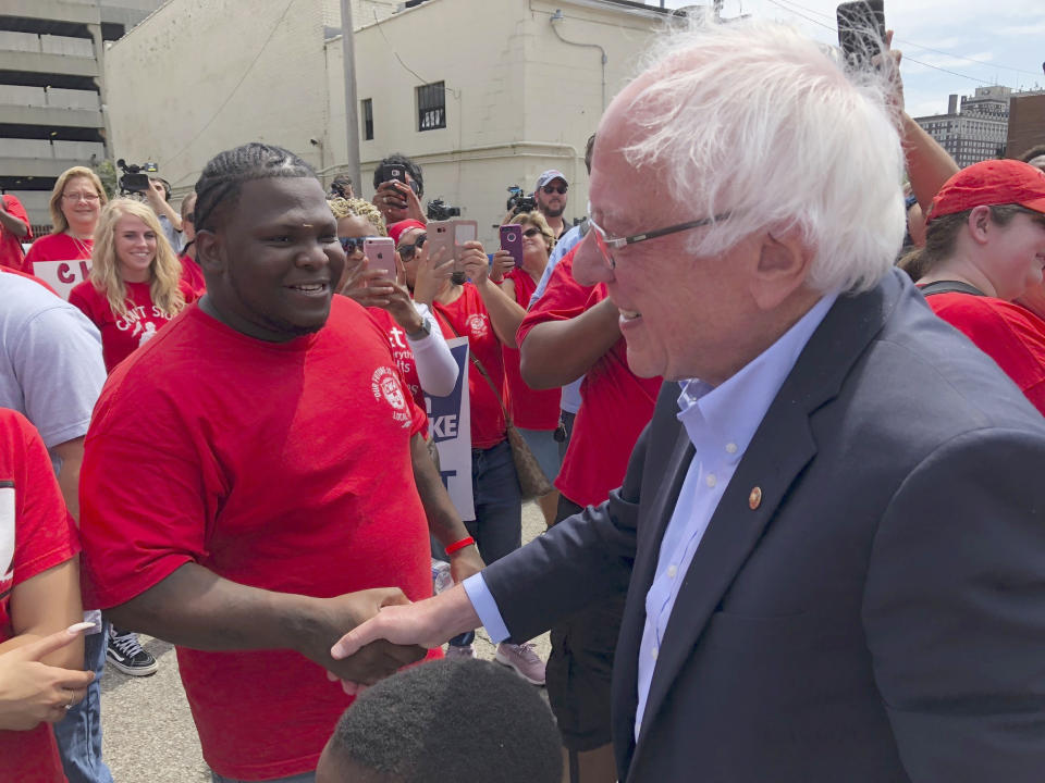Democratic presidential candidate Sen. Bernie Sanders greets striking telecommunications workers on Sunday, Aug. 25, 2019, during a stop in Louisville, Ky. Sanders spoke to the striking workers before attending a rally to promote Democratic initiatives being bottled up in the Republican-led Senate. (AP Photo/Bruce Schreiner)