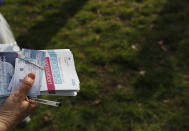 Vaccination leaflets ready to be given out during the pilot project of pop up vaccination drive 'Vaxi Taxi' in Kilburn, London, Sunday, Feb. 28, 2021. The pilot scheme, funded by the Covid Crisis Rescue Foundation, aims to help ferry supplies and patients to temporary clinics set up in faith and community centres across the capital. People don’t even need to leave the backseat if they didn’t want to in order to receive their inoculation. (AP Photo/Alastair Grant)