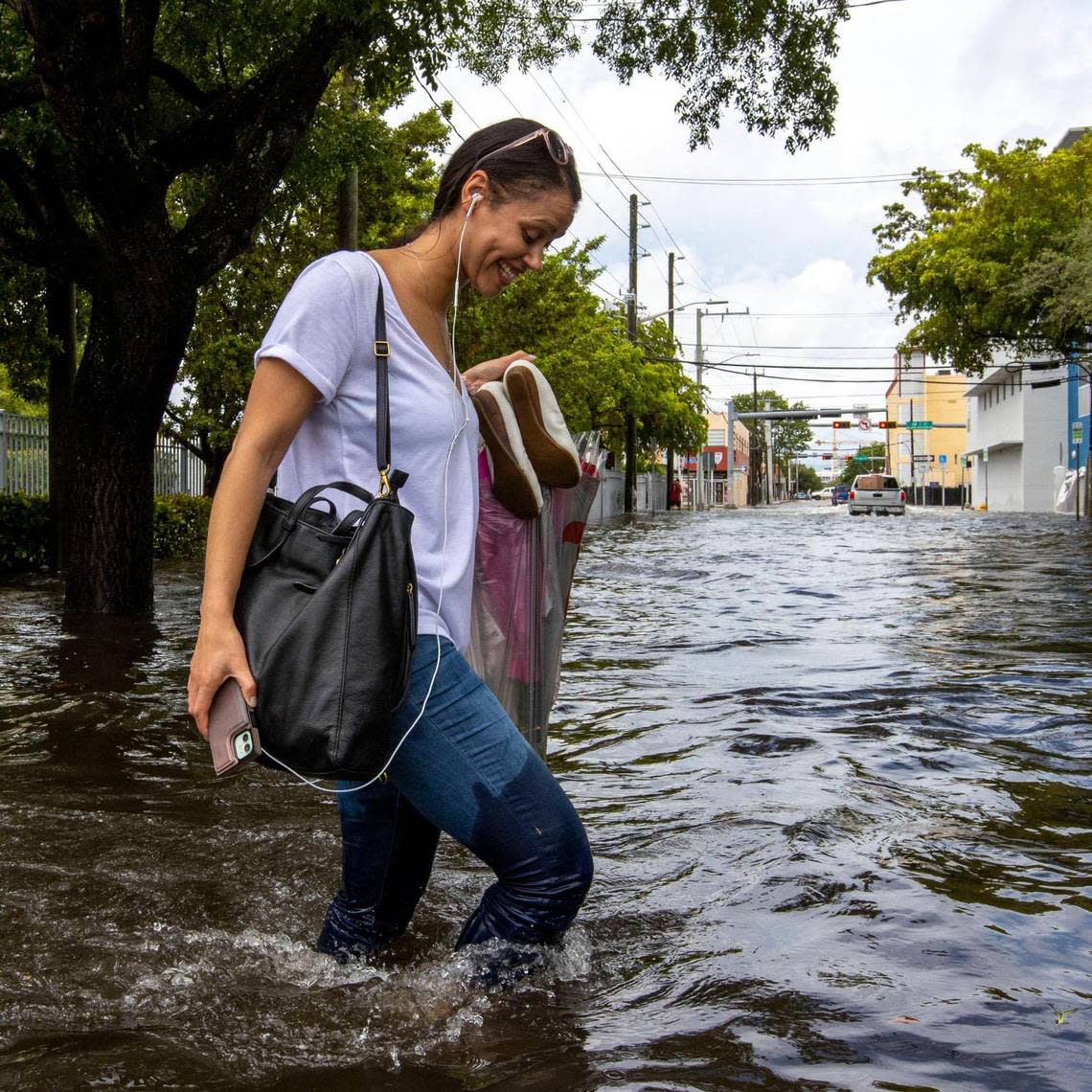 A pedestrian walks through floodwaters on Southwest Second Street in the Little Havana neighborhood of Miami, Florida, on Saturday, June 4, 2022. Daniel A. Varela/dvarela@miamiherald.com