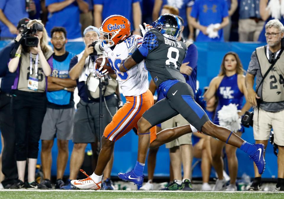 Tyrie Cleveland stiff-arms Derrick Baity Jr as he makes his way into the end zone. (Getty Images)
