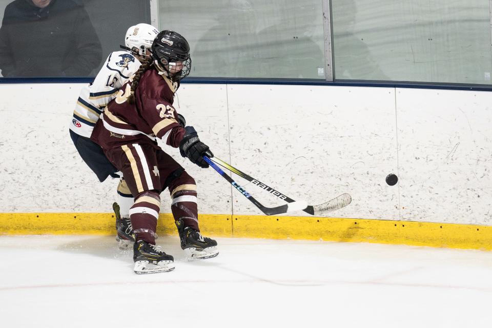 Algonquin's Emily Johns and Shrewsbury's Jessie Kenny make contact into the boards during Wednesday night's game at NorthStar Ice Sports in Westborough.