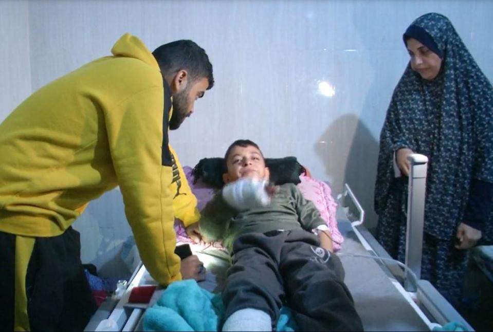 Rajaa Hamad, at right, stands next to the hospital bed of her nephew, Mohammad Hamad, 9, who was the only member of his immediate family to escape from the wreckage of their home after it was hit by an Israeli airstrike in northern Gaza, Feb. 28, 2024. / Credit: CBS News