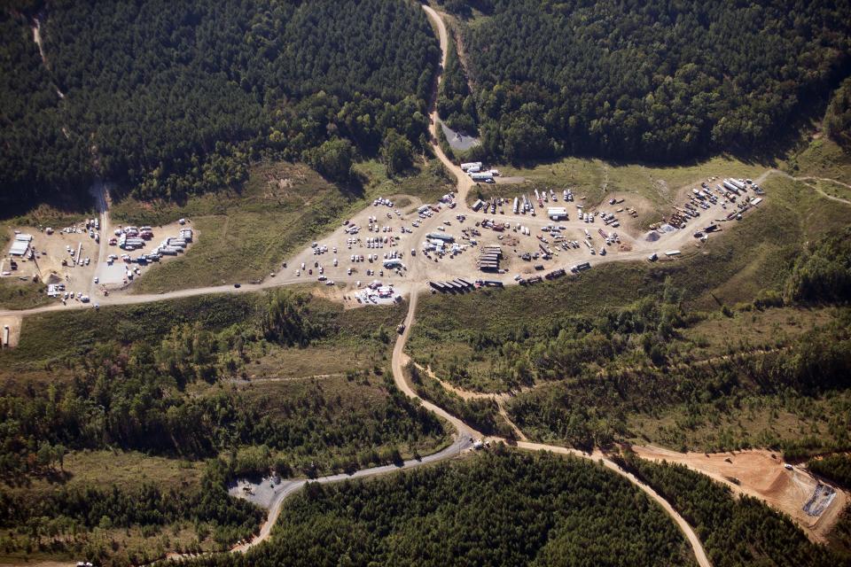 FILE - In this Sept. 20, 2016 file photo vehicles are seen near Colonial Pipeline in Helena, Ala. A major pipeline that transports fuels along the East Coast says it had to stop operations because it was the victim of a cyberattack. Colonial Pipeline said in a statement late Friday that it “took certain systems offline to contain the threat, which has temporarily halted all pipeline operations, and affected some of our IT systems.” (AP Photo/Brynn Anderson, File)