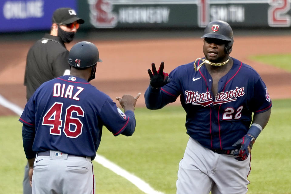 Minnesota Twins' Miguel Sano (22) is congratulated by third base coach Tony Diaz (46) while rounding the bases after hitting a two-run home run during the seventh inning in the first game of a baseball doubleheader against the St. Louis Cardinals Tuesday, Sept. 8, 2020, in St. Louis. (AP Photo/Jeff Roberson)