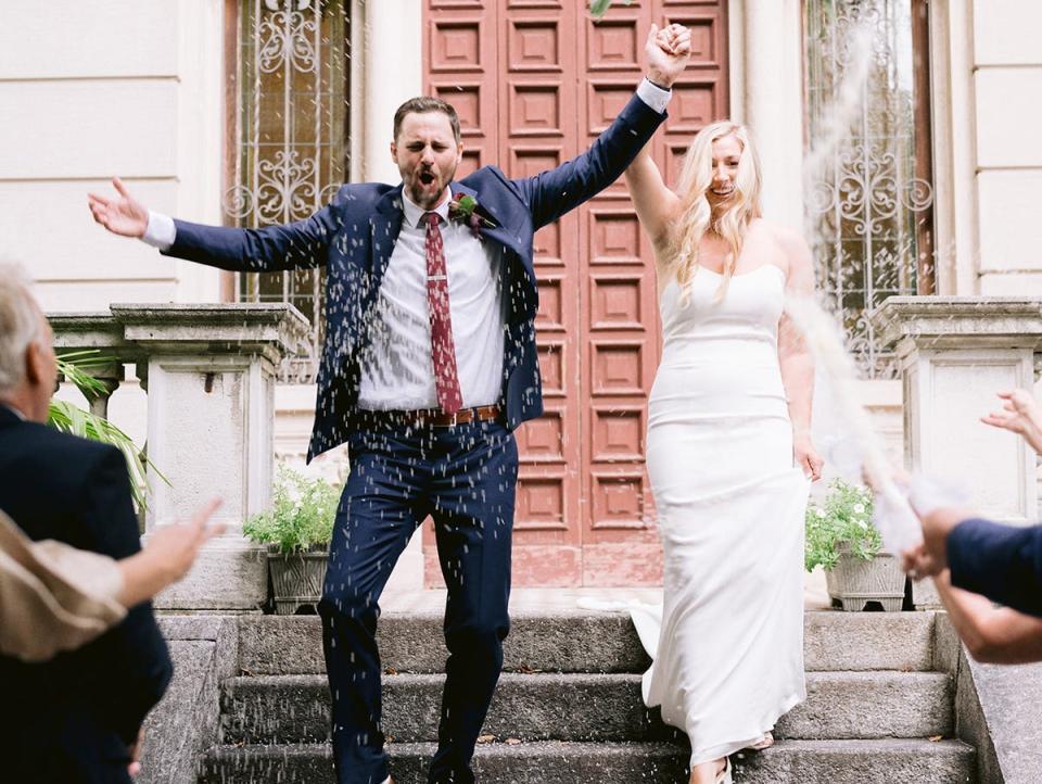 A couple rejoicing whilst walking down the stairs.