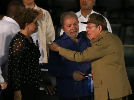 Former Brazilian Presidents Dilma Rousseff and Luiz Inacio Lula da Silva speak with Cuban President Raul Castro as they attend a tribute to former Cuban leader Fidel Castro in Santiago de Cuba, Cuba, December 3, 2016. REUTERS/Carlos Barria