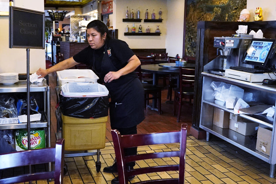 A waitress works at a restaurant in Chicago, Thursday, Jan. 5, 2023. America’s employers added a solid 223,000 jobs in December, evidence that the economy remains healthy yet also a sign that the Federal Reserve may still have to raise interest rates aggressively to slow growth and cool inflation. (AP Photo/Nam Y. Huh)