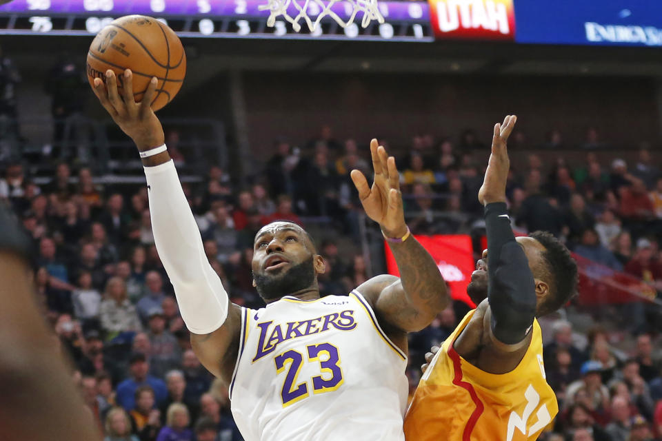 Utah Jazz forward Jeff Green, right, defends against Los Angeles Lakers forward LeBron James, left, as he drives to the basket in the first half during an NBA basketball game Wednesday, Dec. 4, 2019, in Salt Lake City. (AP Photo/Rick Bowmer)