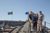 CAPTION CORRECTS THE DATE - Britain's Prince Harry, left Australia's Prime Minister Scott Morrison, right, and Invictus Games representatives climb the Sydney Harbour Bridge in Sydney, Friday, Oct. 19, 2018. Prince Harry and his wife Meghan are on day four of their 16-day tour of Australia and the South Pacific. (AP Photo/Steve Christo, Pool)