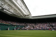 Switzerland's Roger Federer serves during the men's singles second round match against Richard Gasquet of France on day four of the Wimbledon Tennis Championships in London, Thursday July 1, 2021. (AP Photo/Alberto Pezzali)