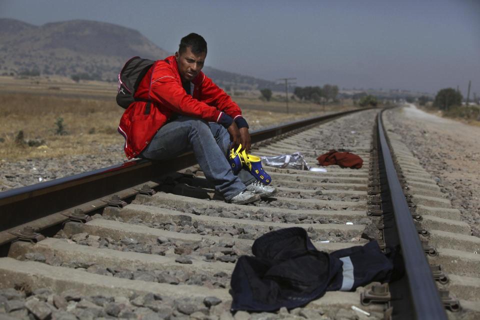 Mario Vazquez Santiago, a migrant from Guatemala, waits for a northbound train on the outskirts of Mexico City, Wednesday, Jan. 25, 2017. President Donald Trump signed two executive orders on Wednesday to jumpstart construction of a U.S.-Mexico border wall and strip funding for so-called sanctuary cities, which don't arrest or detain immigrants living in the U.S. illegally. (AP Photo/Marco Ugarte)