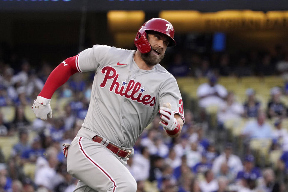 Philadelphia Phillies' Bryce Harper rounds first on his way to a double during the first inning of a baseball game against the Los Angeles Dodgers Saturday, May 14, 2022, in Los Angeles. (AP Photo/Mark J. Terrill)