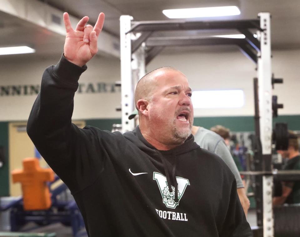 Venice High head football coach John Peacock calls out lifts during a team weightlifting session on Tuesday.
