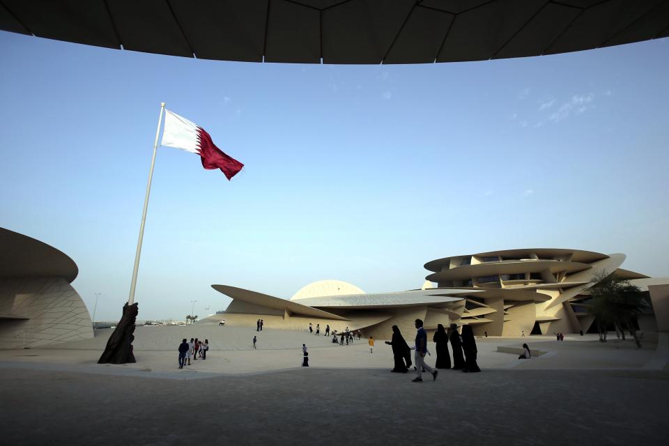 FILE - People visit the National Museum of Qatar in Doha, Qatar, Monday, April 22, 2019. As many as 1.7 million people could pour into Qatar during the upcoming 2022 FIFA World Cup that begins this November — representing over half the population of this small, energy-rich Arab nation. (AP Photo/Kamran Jebreili, File)