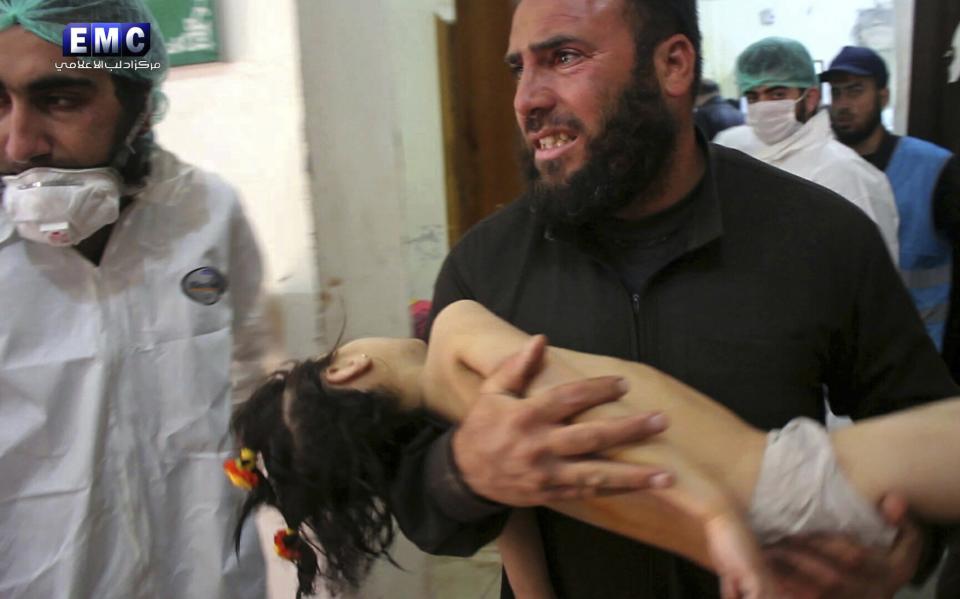 A man carries a child following a suspected chemical attack at a makeshift hospital in the town of Khan Shaykhun, Syria, on April 4, 2017. (Photo: Edlib Media Center/AP)